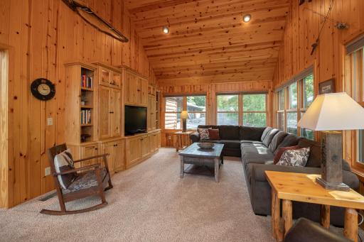 Main floor den with vaulted ceilings and custom cabinetry