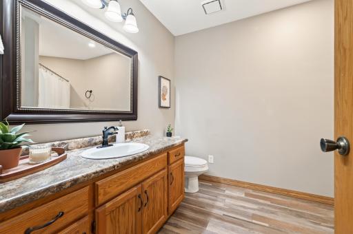 The main floor full bathroom features luxury vinyl flooring.