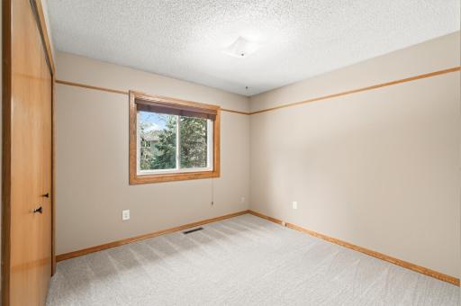 Bedroom 3 on the main level overlooking the private backyard.