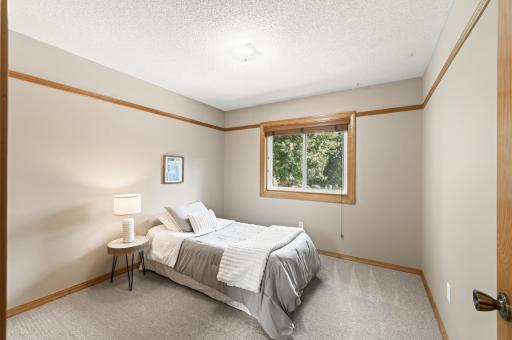 Bedroom 2 on the main level overlooking the private backyard.