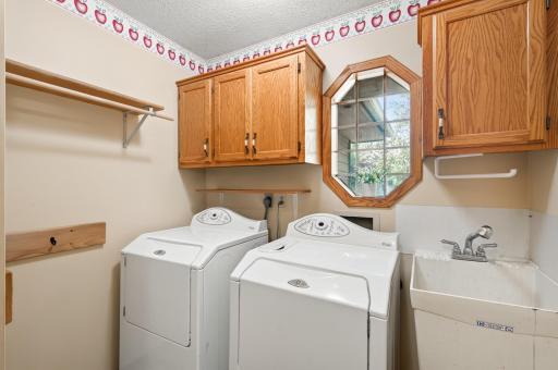 The laundry room is located near the attached garage entrance and across the hall from the large entry closet.