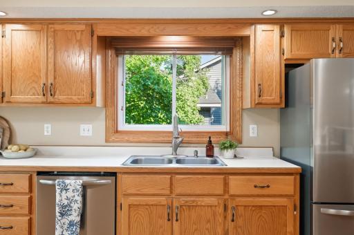 The kitchen is filled with natural light with a window above the sink and the large bay window on the front of the home.