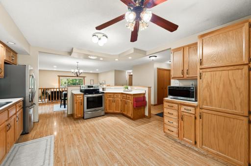 The large kitchen features stainless steel appliances, ample storage room, and a center island.
