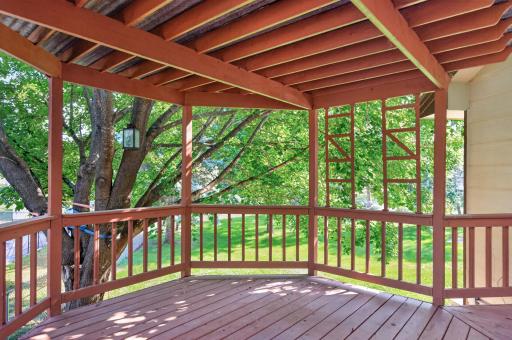 The covered portion of the deck has a beautiful view of the backyard.