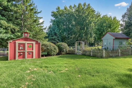 Storage shed and established garden located in the back of the yard.