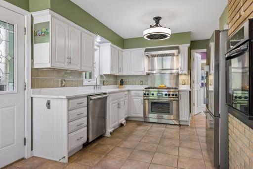 Under-cabinet lighting, quartz countertops, an oversized farmhouse sink