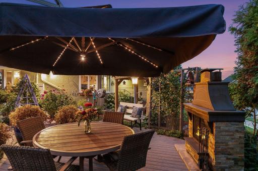 Umbrella, outdoor fireplace, table + chairs shown included with sale