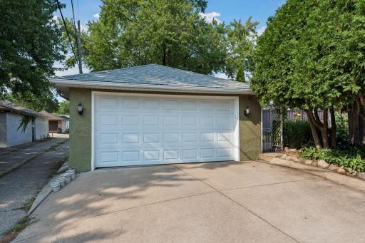 Pristine concrete driveway with a new garage door