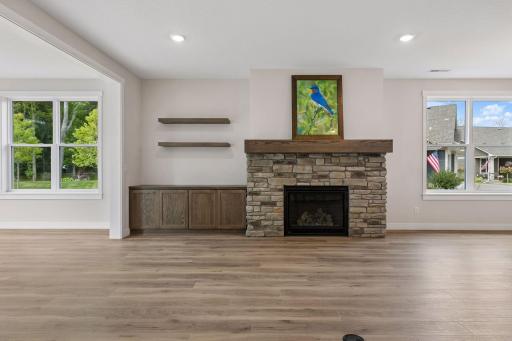 Stunning gas fireplace with floating shelves and built-in storage