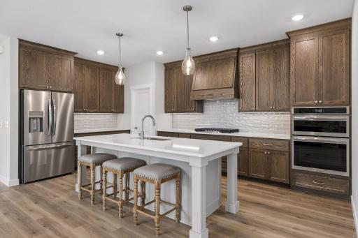 Stainless steel appliances and decorative tile backsplash