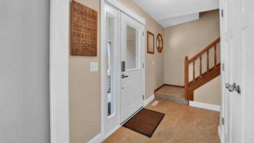 Tile entry way with large coat closet.