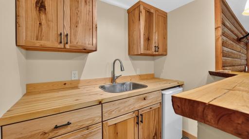 Custom alder cabinetry in the lower level family room wet bar.