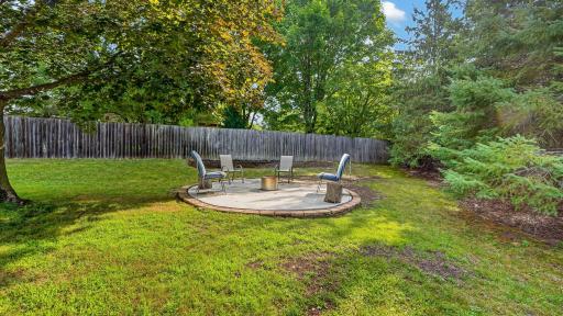 Custom concrete patio area in the rear of the yard.