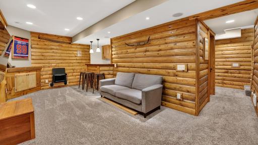Feel the fantastic Northwoods vibe with custom woodwork in the lower-level family room.