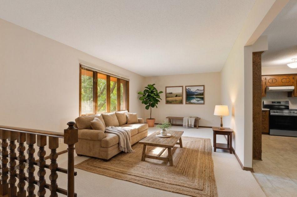 This large living room is filled with natural light from bright windows and offers generous space with a comfortable flow. (Virtually Staged)
