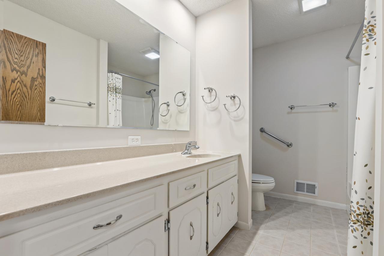 The main-level full bathroom features a generous vanity with ample storage and counter space, creating a bright, practical everyday space.