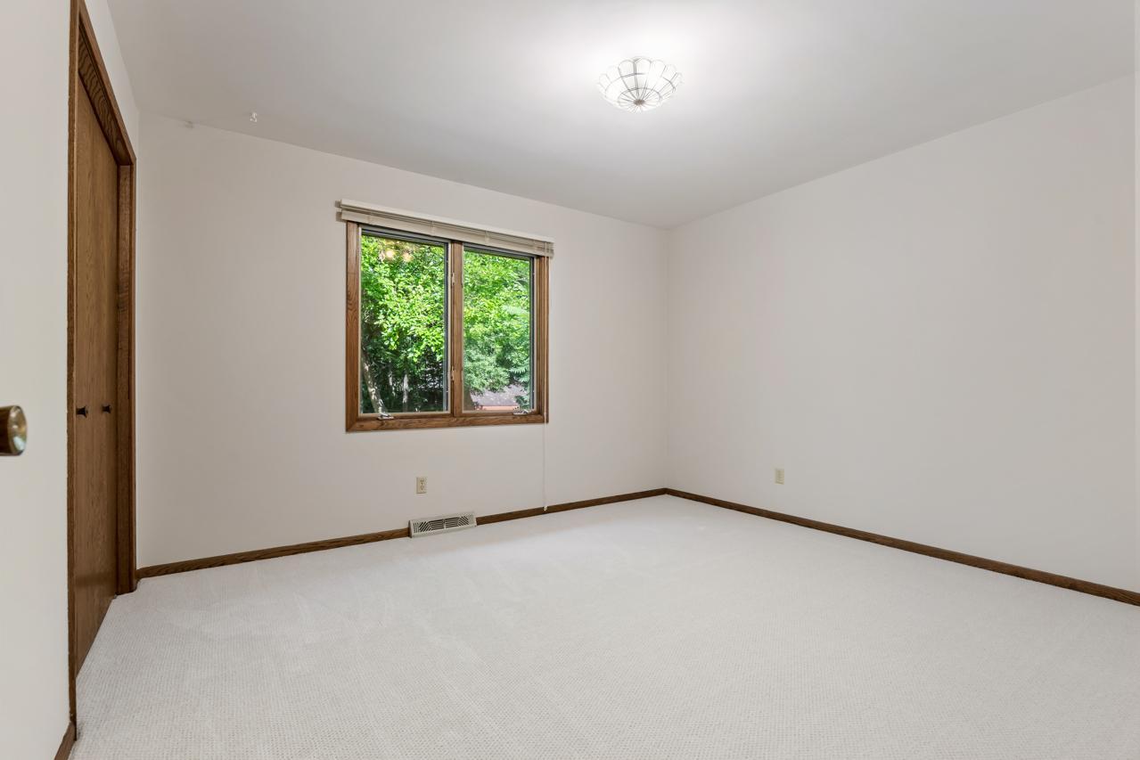 The third bedroom offers a generous closet and overlooks the private backyard, bringing in natural light and a quiet, private setting.