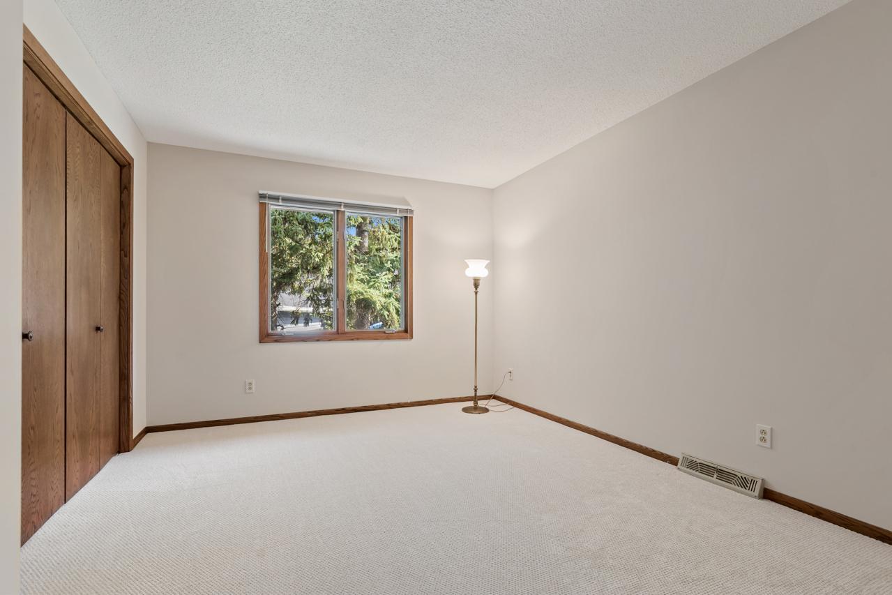 Main-level second bedroom with new carpet and fresh paint.
