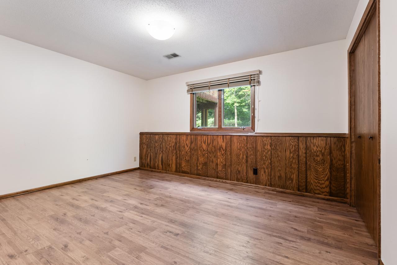 The fourth bedroom (lower level) features a large closet for generous storage.