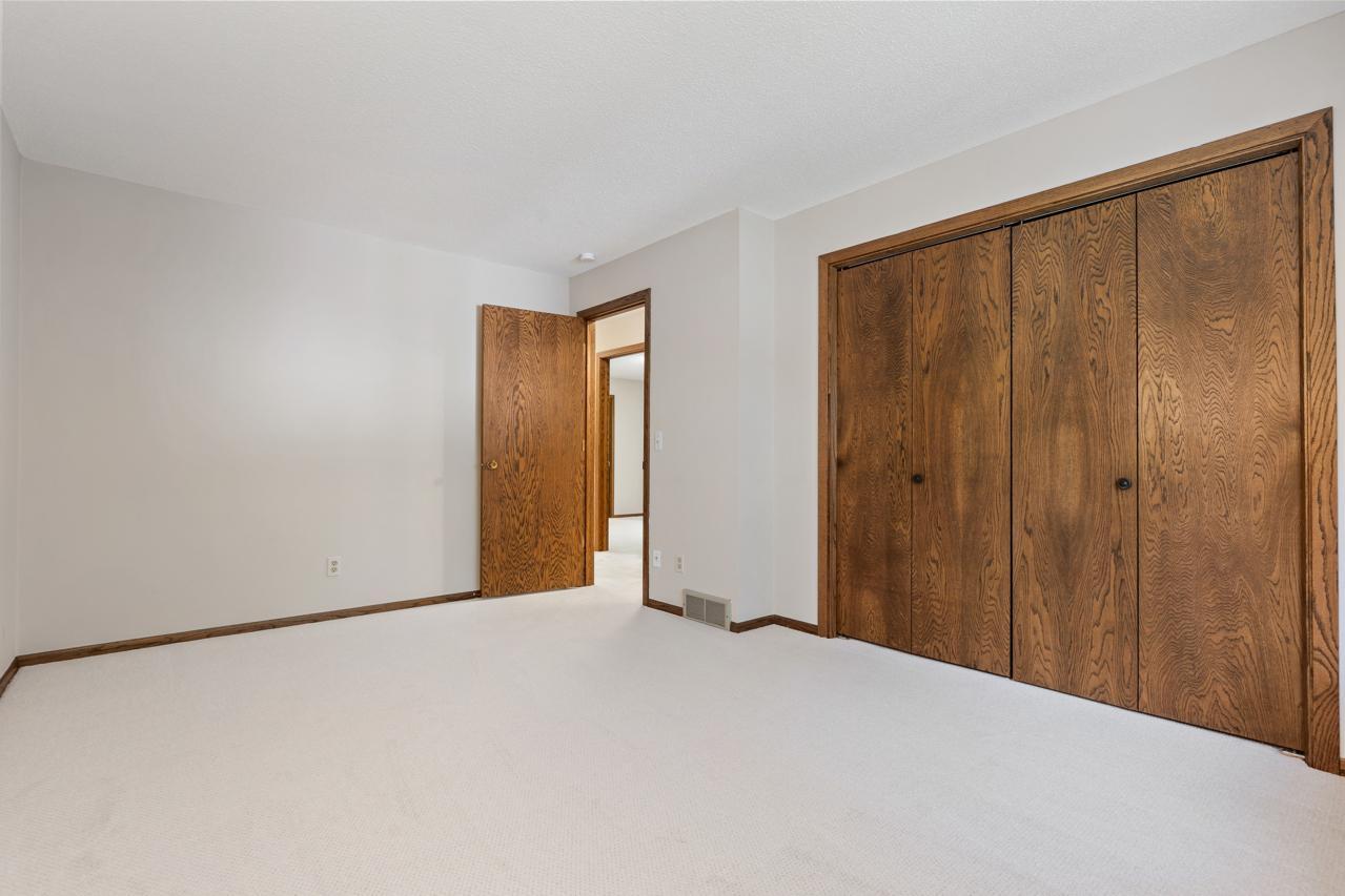Another view of the second main-level bedroom featuring a generous closet for added storage and convenience.