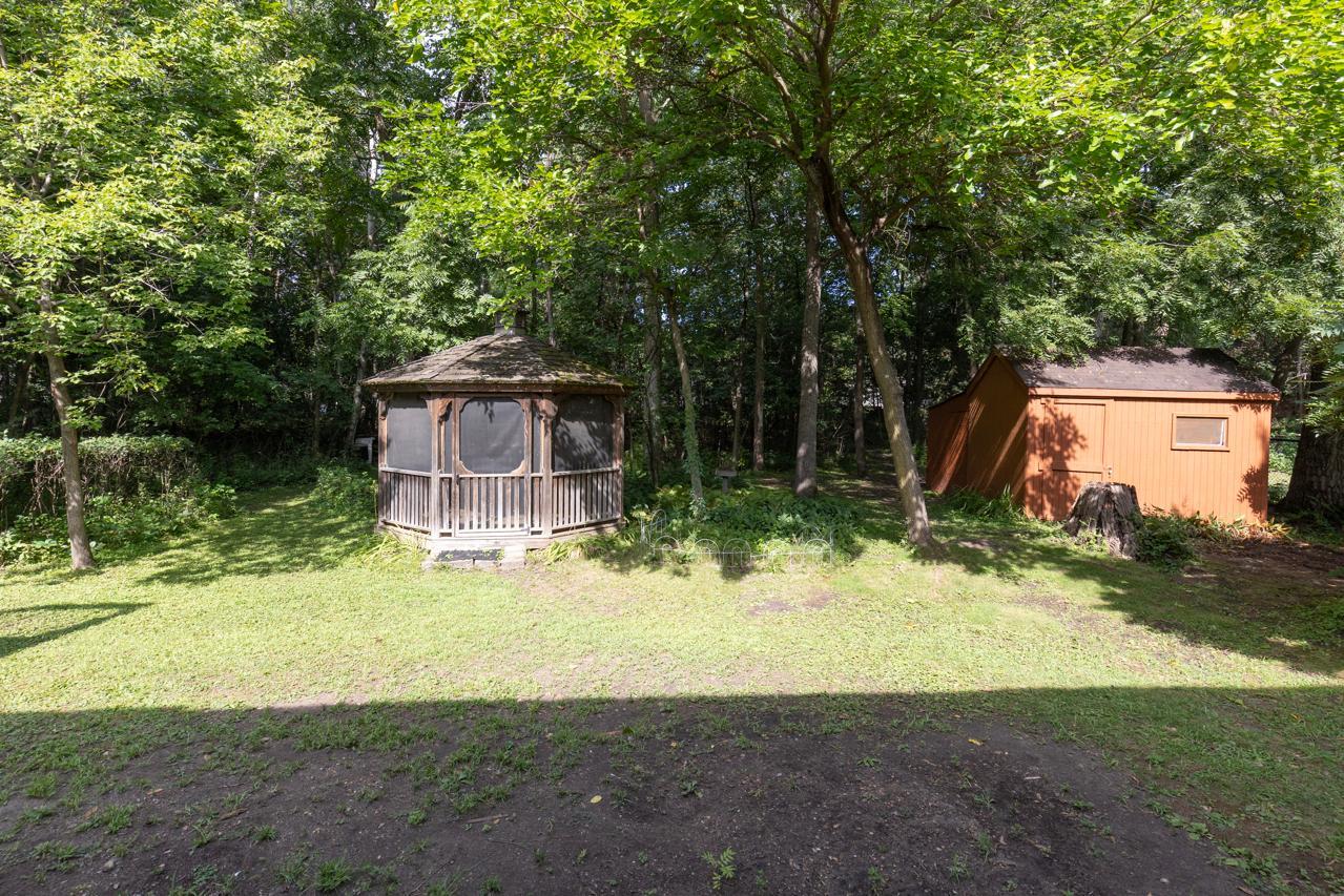 The backyard offers a lovely gazebo for outdoor relaxation and a versatile shed with an attached workroom—ideal for projects, storage, or hobbies.