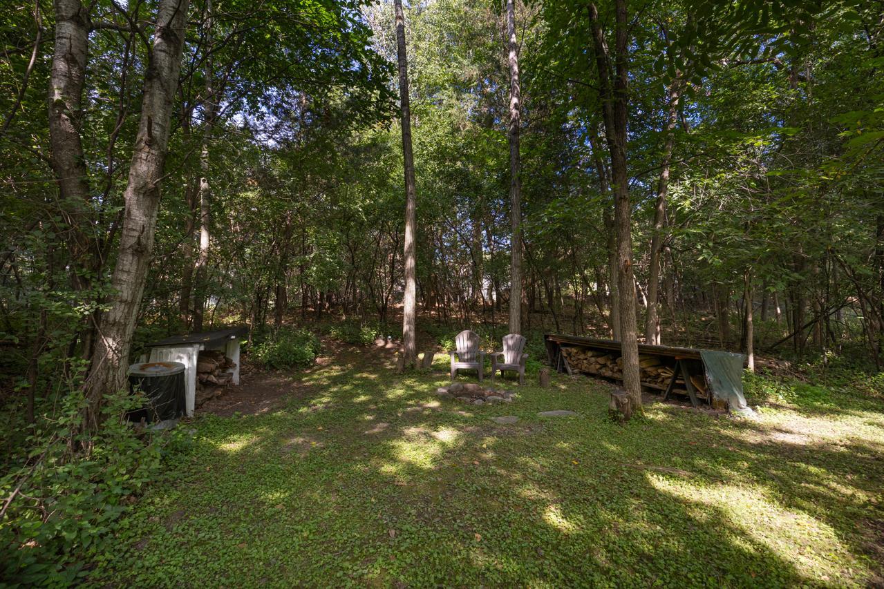 Enjoy a private backyard fire pit, complete with ample wood, ready for cozy evenings.