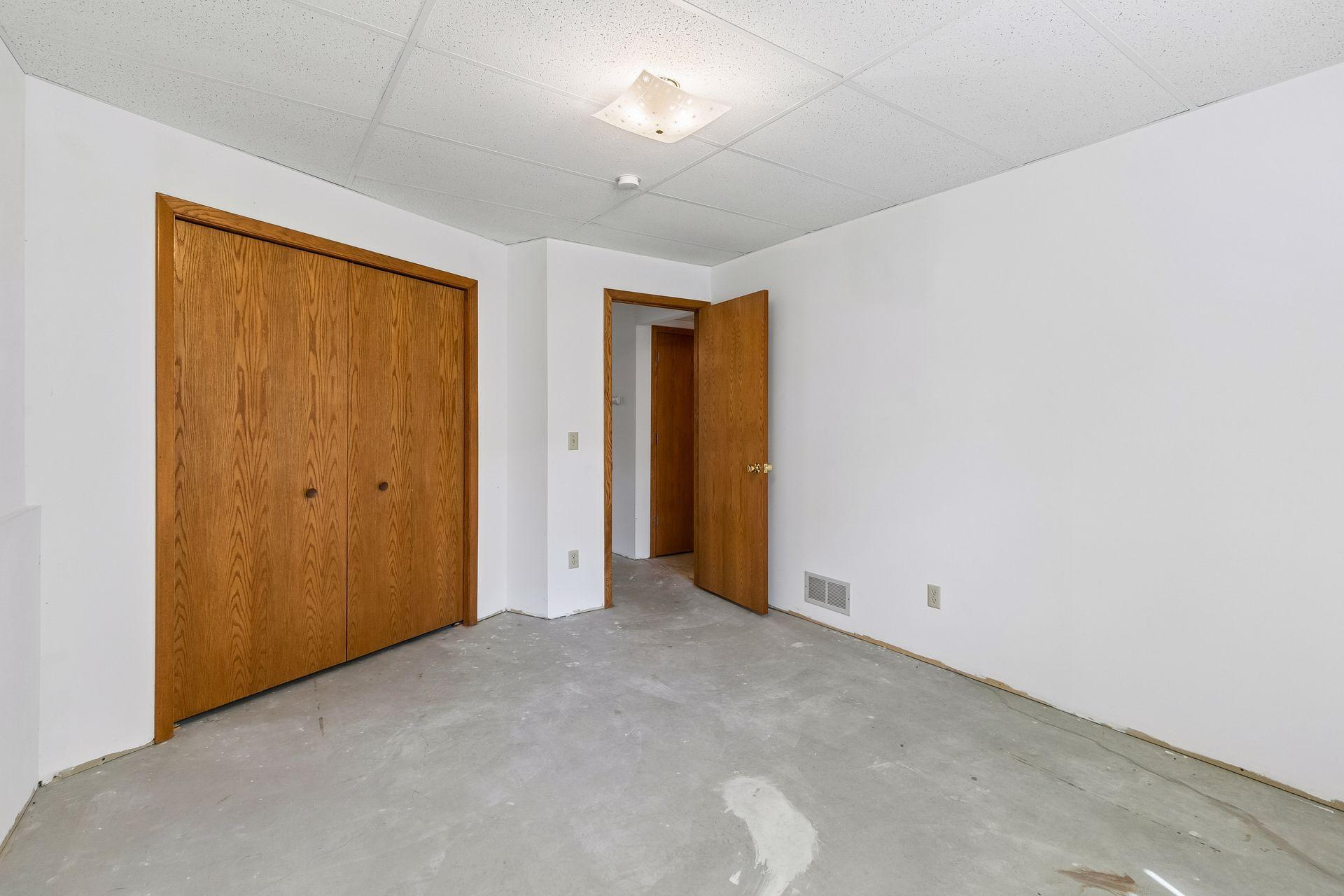 Fourth bedroom on the lower level. A large closet and a bathroom across the hall.