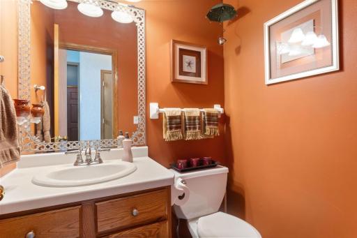 Convenient main-level half bath located just off the foyer, featuring a stylish ceramic tile floor and an ideal layout for guests and everyday living.