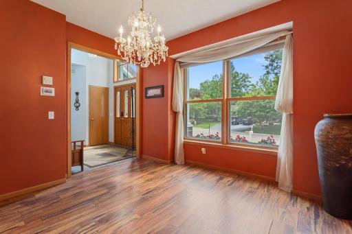 Light-filled dining room with two south-facing windows, plank flooring and easy kitchen access. The foyer features vaulted ceilings, a half-round window, beautiful beveled-glass entry door, porcelain tile and coat closet, plus a handy tiled mudroom.