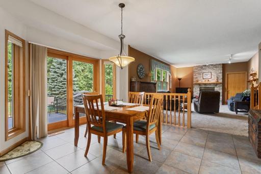 Conveniently located off the kitchen, the informal dining area features easy-care porcelain tile and a sliding door that opens to the two-tier deck and screened porch—perfect for everyday meals, morning coffee, and effortless entertaining.