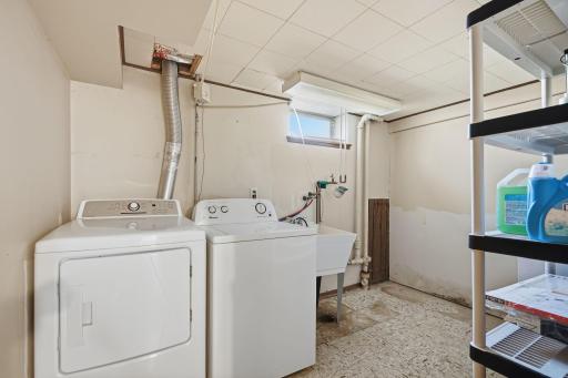 The large lower level laundry room has extra space for a folding table and shelving.