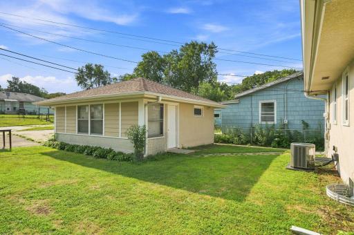 The 1 1/2 car garage is surrounded by landscaping and only steps from the covered porch area. with back alley access and parking.