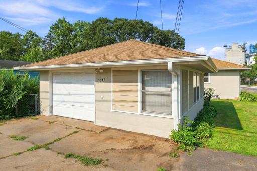 With wide and deep 1 1/2 car garage, there is plenty of space for a workbench and extra storage.