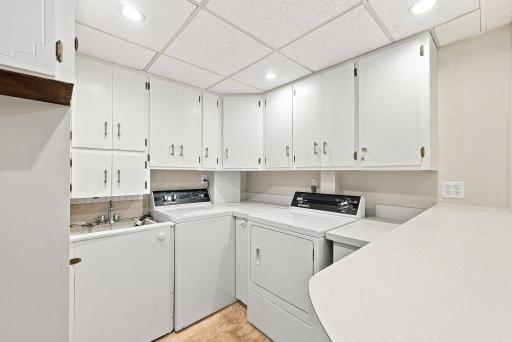 Laundry room in lower level. New flooring is being installed prior to the home going live.