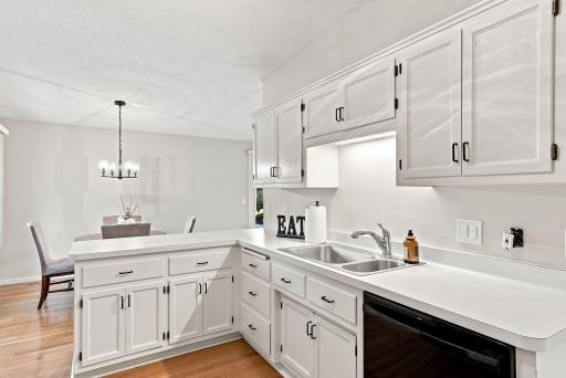 The kitchen has been refreshed with painted cabinets and new hardware.