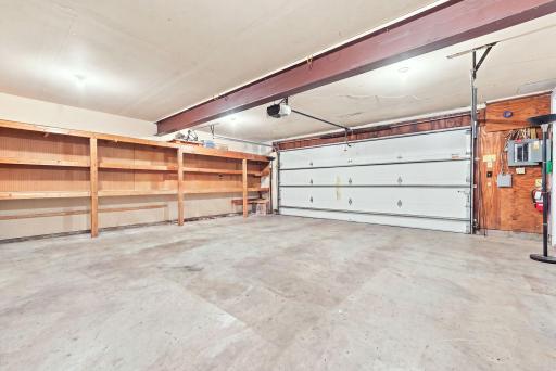 The two-car garage has ample storage space and a heater!