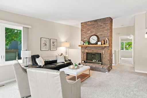 The living room features vaulted ceilings and this gorgeous fireplace.