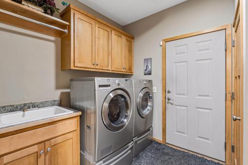 Full-size washer and dryer included. Laundry sink, built-in maple storage cabinets.