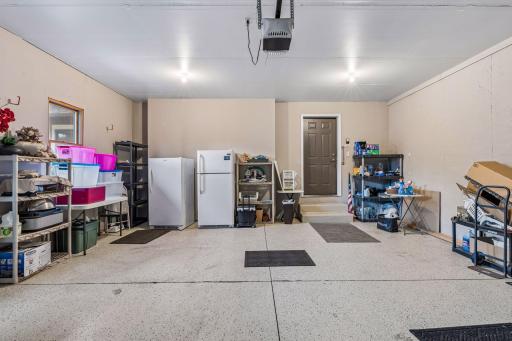 Oversized 2-car garage with finished walls and epoxy floor.