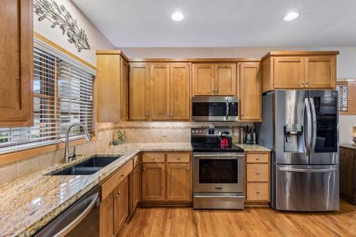 Granite countertops with tile backsplash accents.