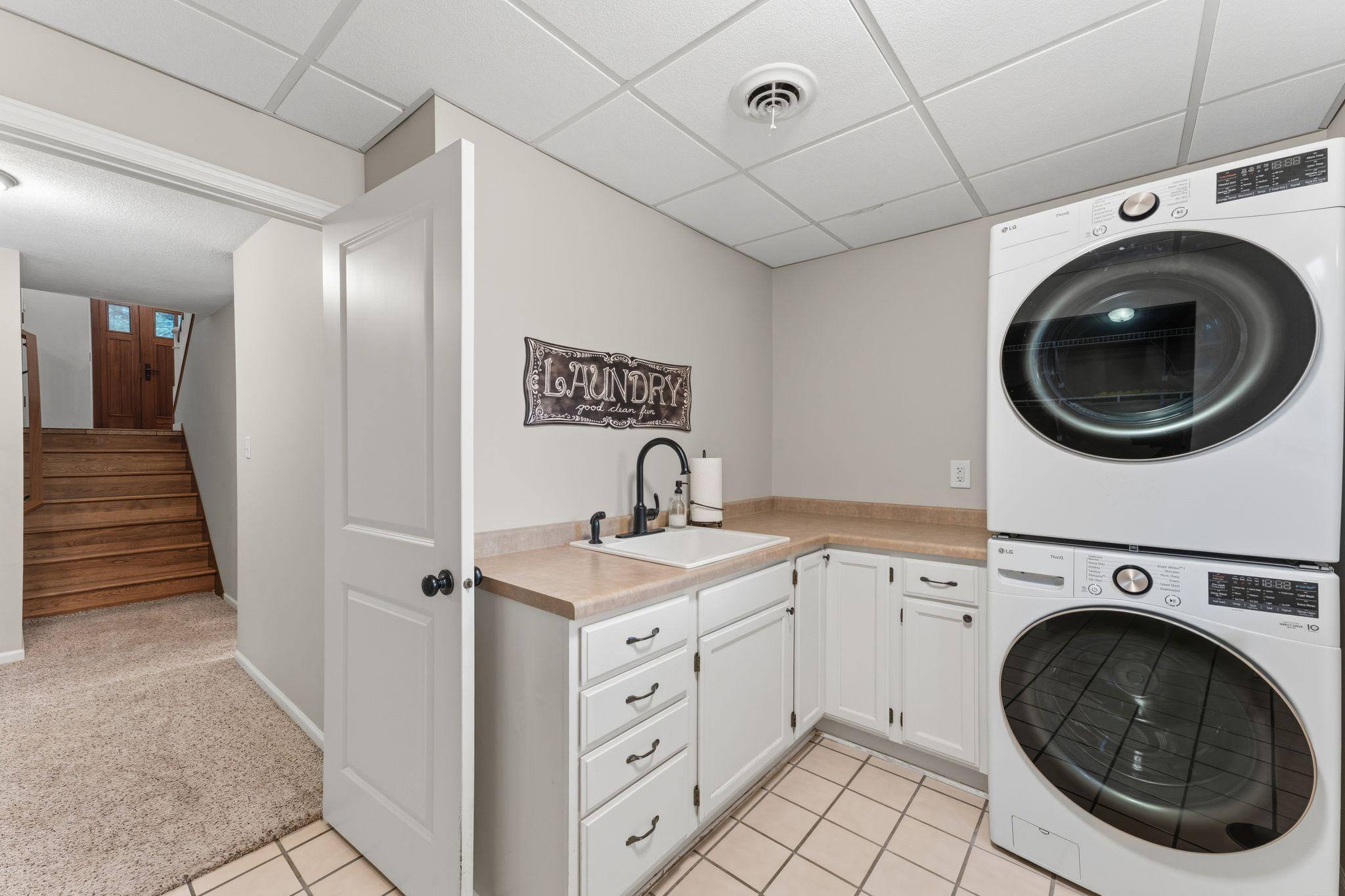 Generous laundry room with utility sink and storage