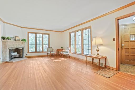 Living room - There are beautiful, elongated windows on the front of the house. On the right side of this photo, you can see the vestibule to the front door.