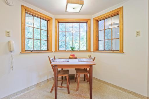 Kitchen - There is space in the kitchen for a table and chairs. The three large windows look out to the private backyard gardens.