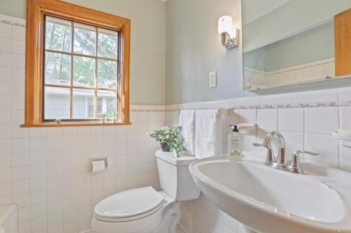Bathroom #1 - This is a 3/4 bath with a large tub and could easily have a shower attachment added to make this a full bathroom. The tile is in perfect condition and it is painted a light blue.