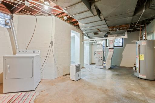 Basement Laundry room - Laundry, Hobby, and Storage Rooms: The furnace is only 1 year old â one less thing to worry about. Straight ahead is a hobby room and an additional storage room.