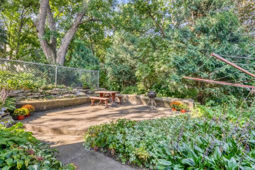 Private patio behind the house. There are lots of established perennial plants that bloom all summer long all around the house.