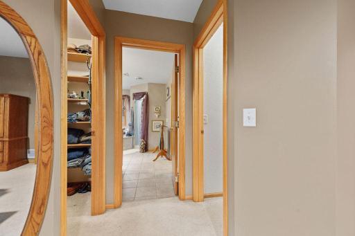 primary closets on left and right and primary bathroom in center
