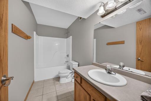 Convenient lower-level full bathroom featuring a tub/shower combination and plenty of space for everyday use or guests.