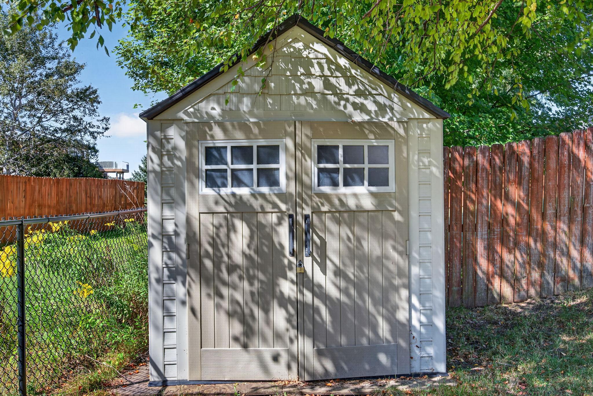 Convenient backyard utility shed provides additional storage for lawn equipment, tools, and outdoor essentials.