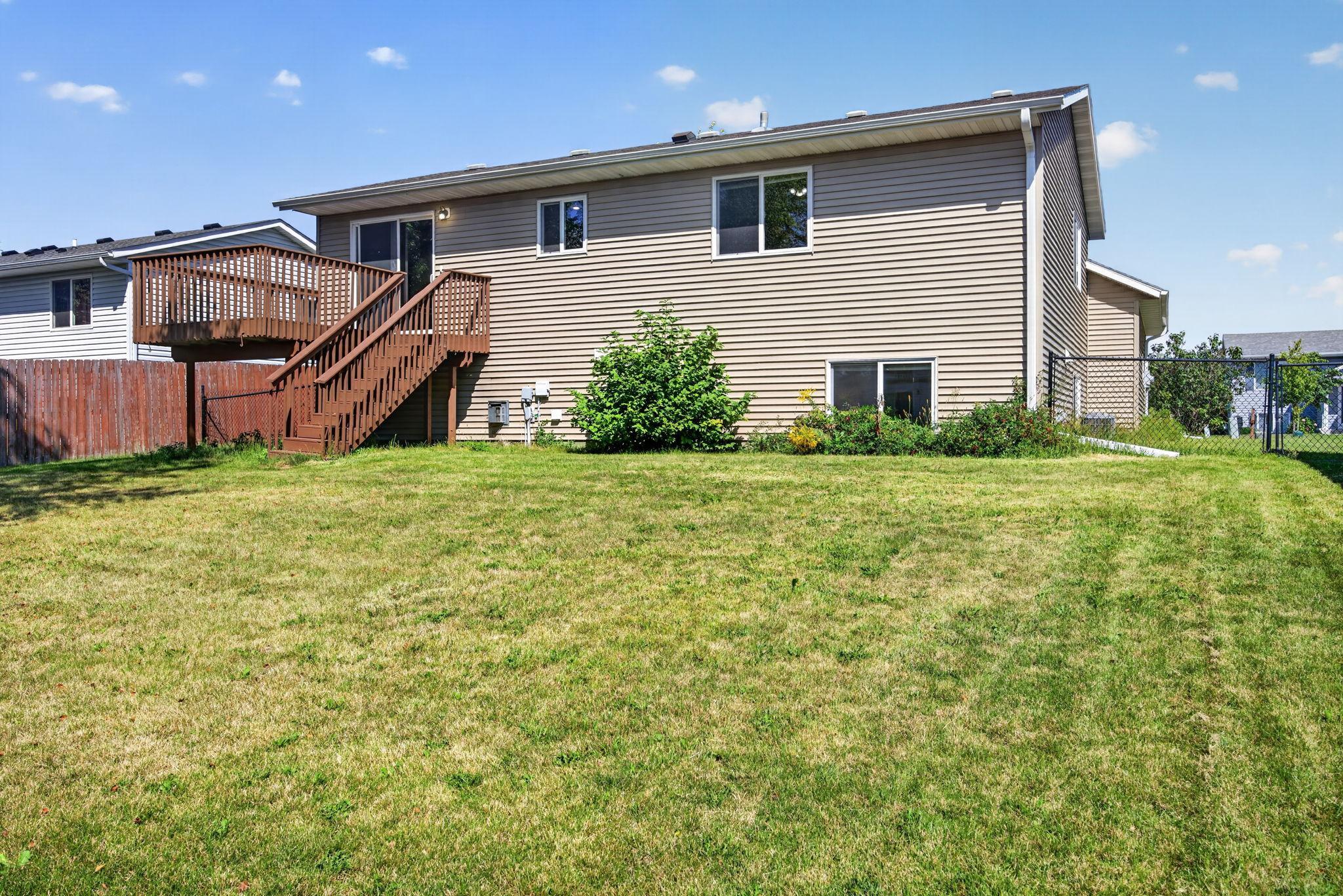 Expansive, fully fenced backyard offering plenty of space for outdoor entertaining, play, pets, gardening, or simply enjoying the outdoors.